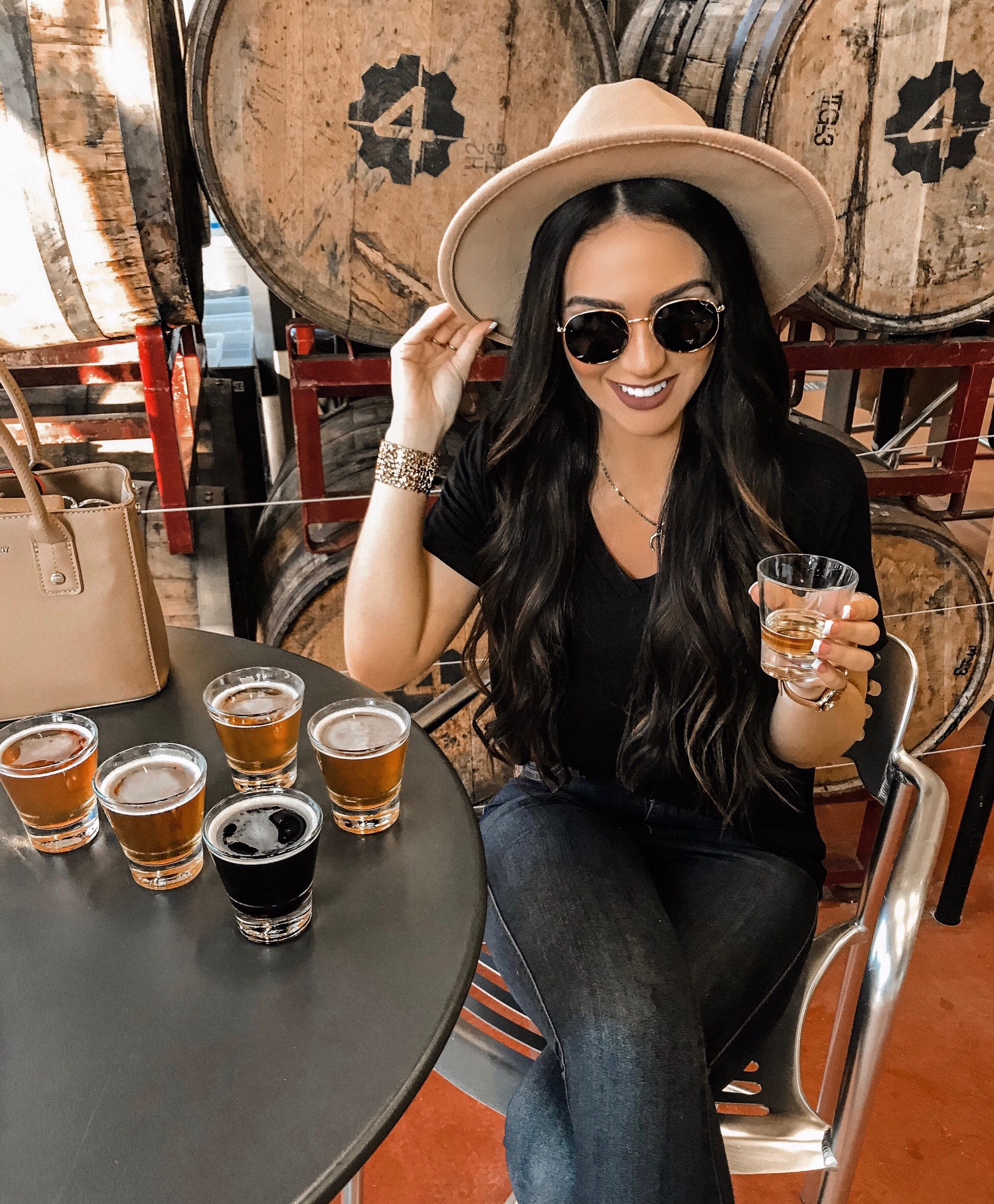 a girl holding a beer smiling