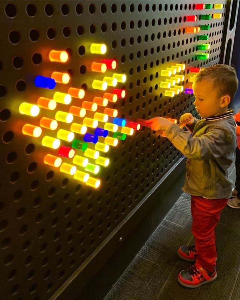 boy playing with science display