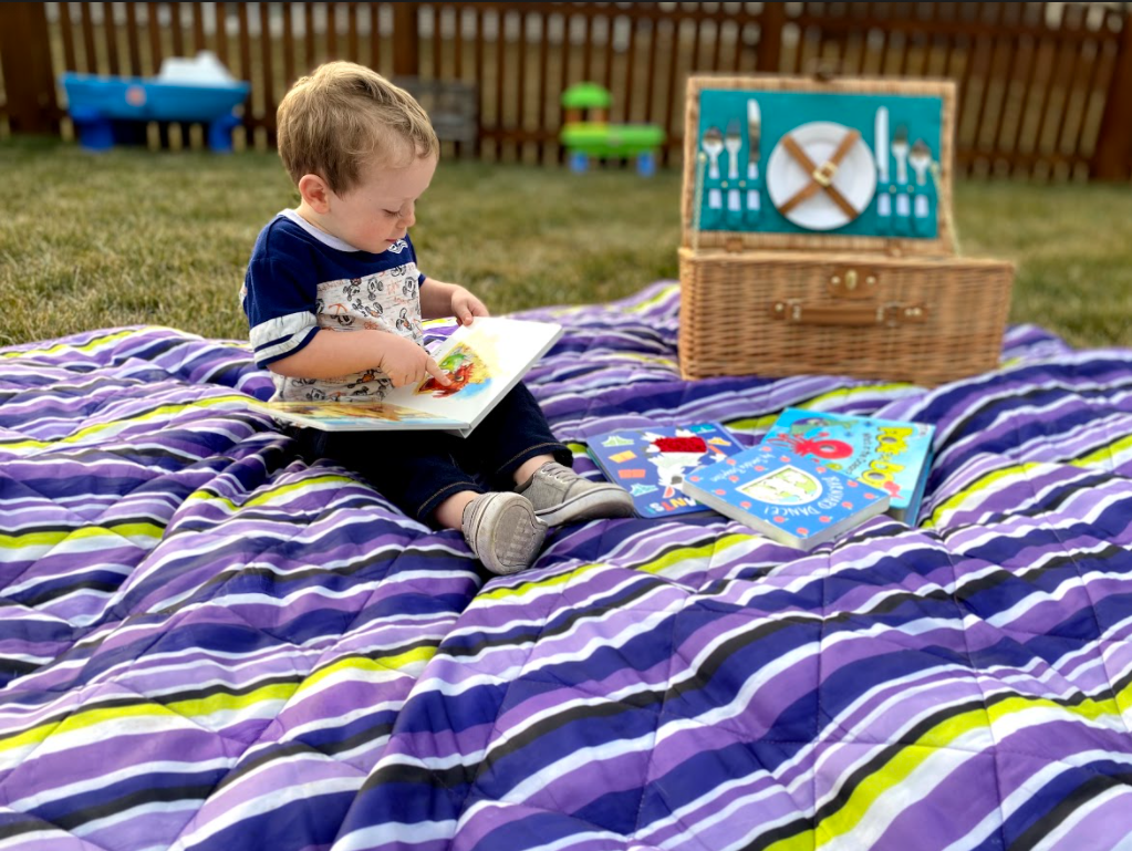boy sitting on picnic blanket