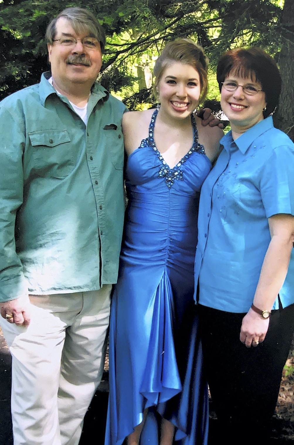 stephanie perry posing and smiling with her mom and dad