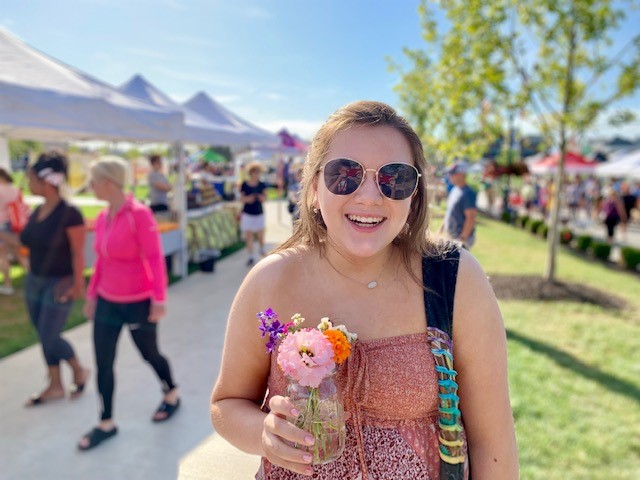girl with flower at farmers market