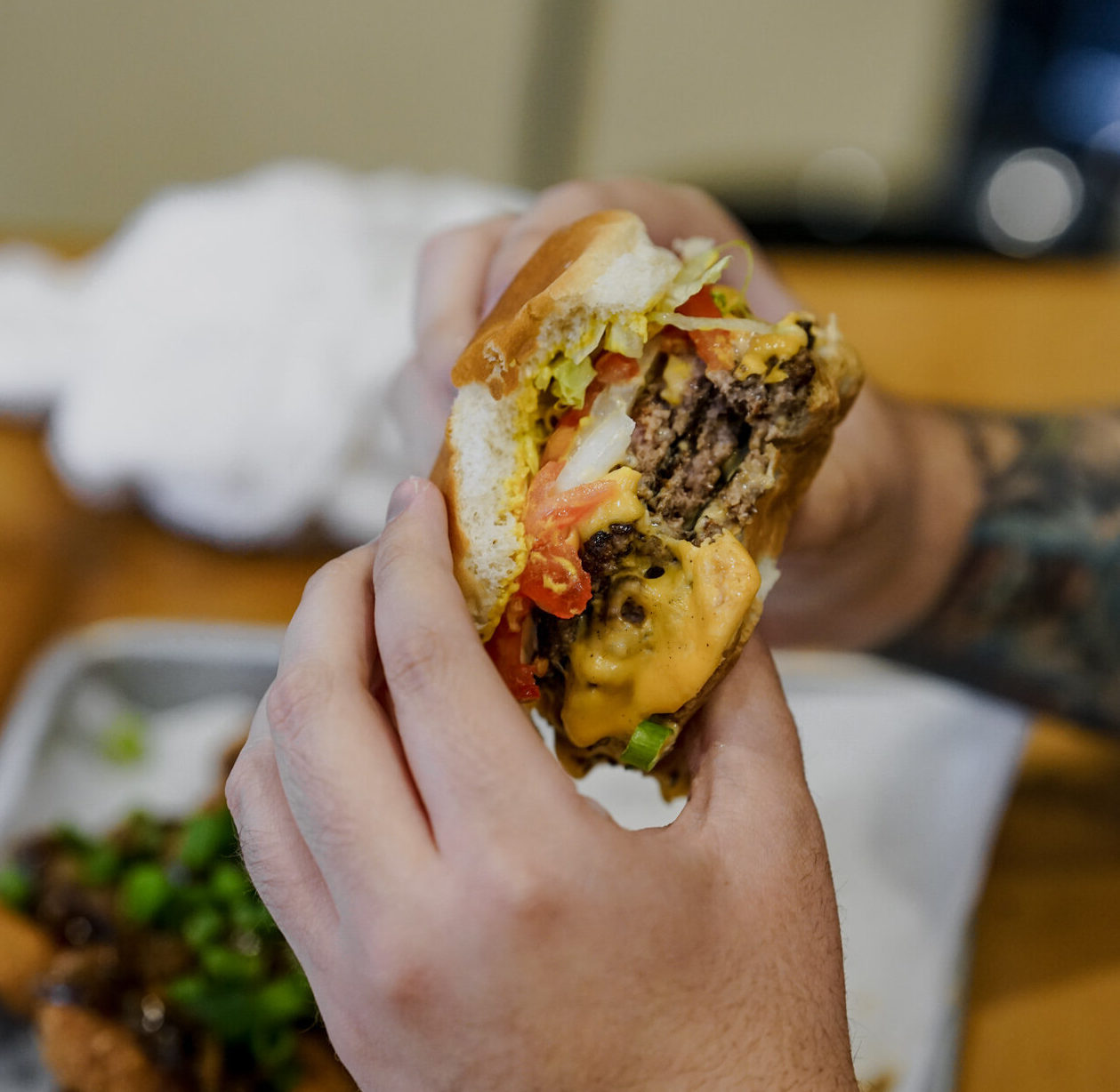 hands holding a burger