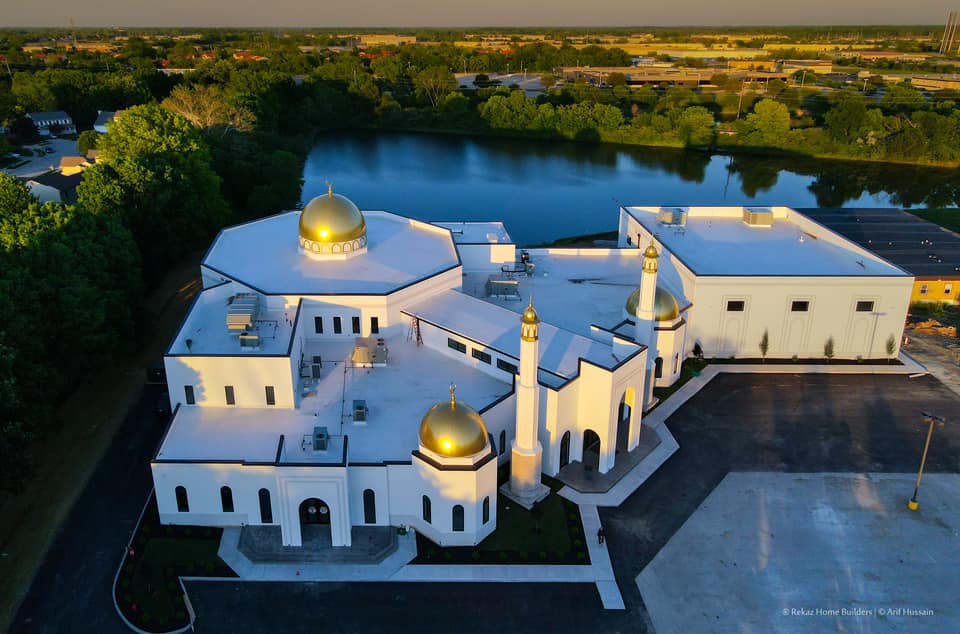 an aerial view of a mosque at sunset
