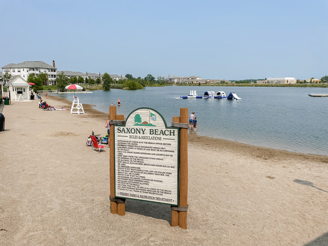 a man made beach with the entrance sign at the front