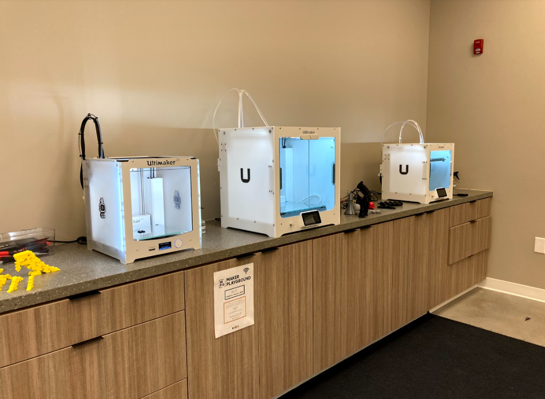 3d printers lined up on a counter
