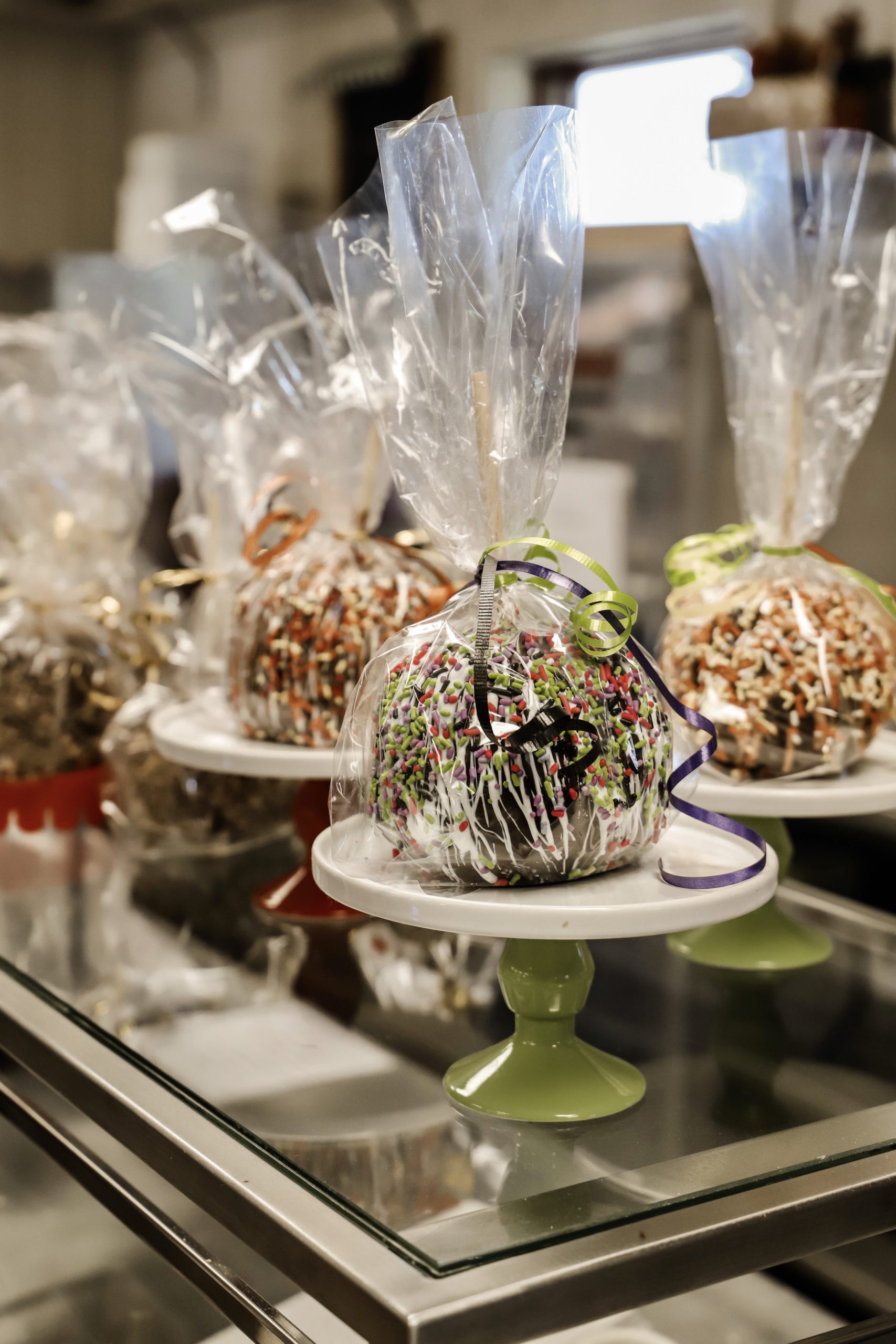 candied apples on a table wrapped in clear wrap