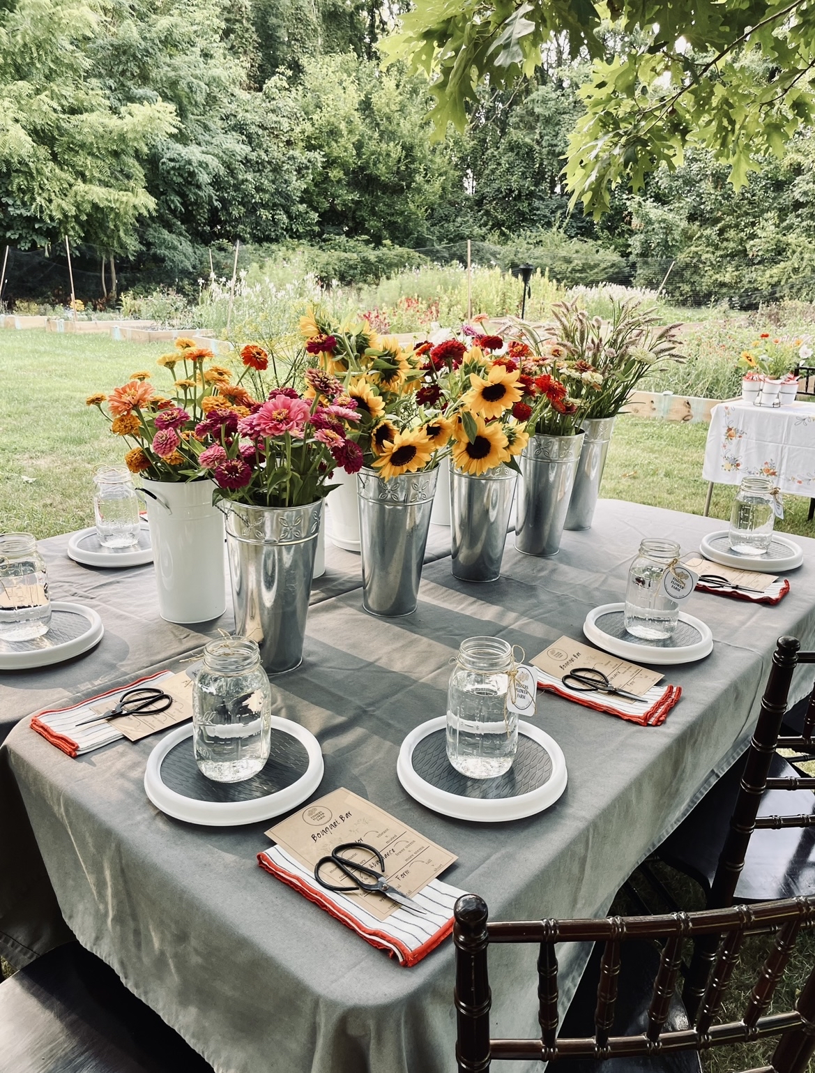 a table set with dishes and flowers in the middle