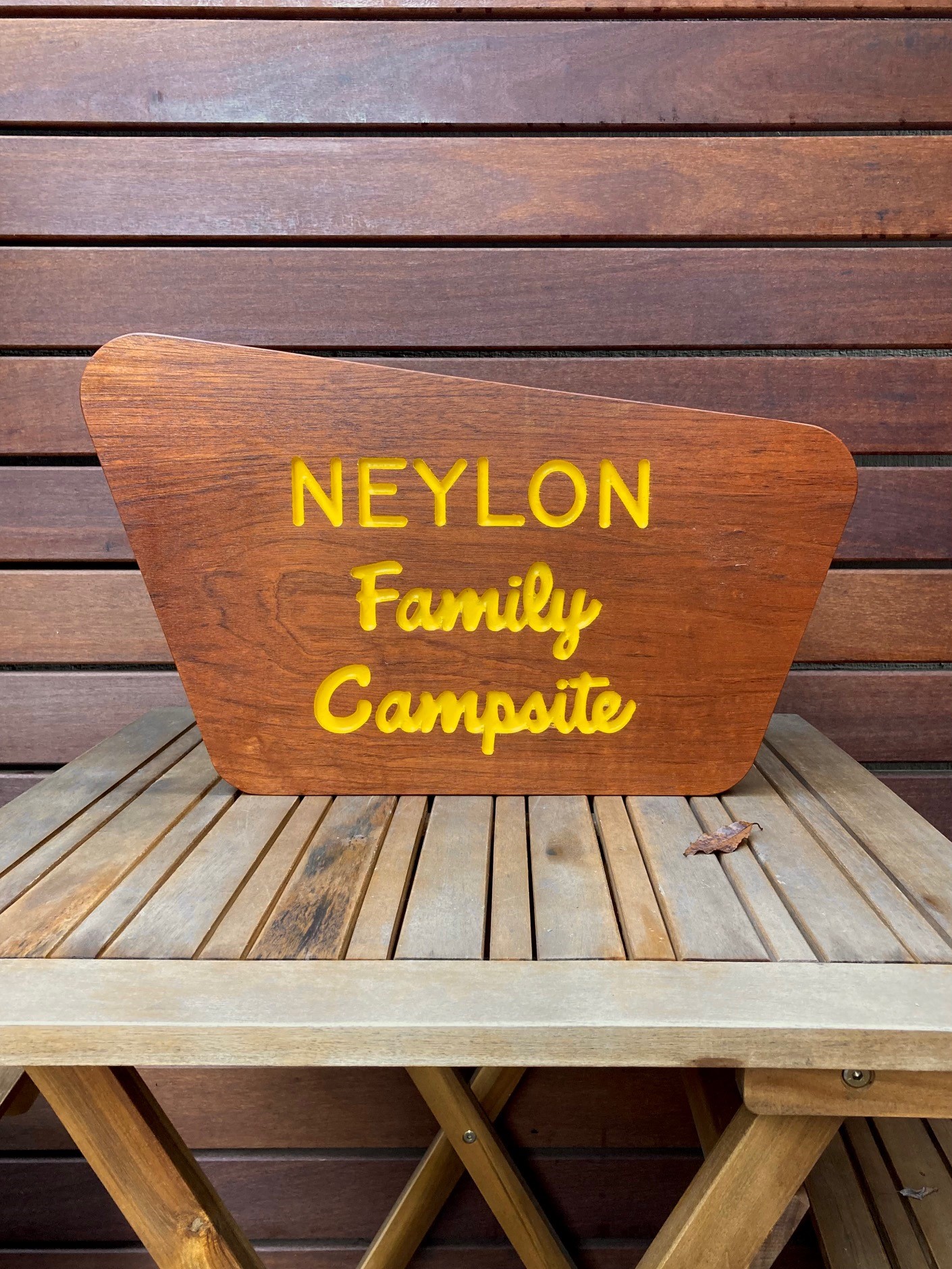 a wooden sign that says Neylon Family Campsite