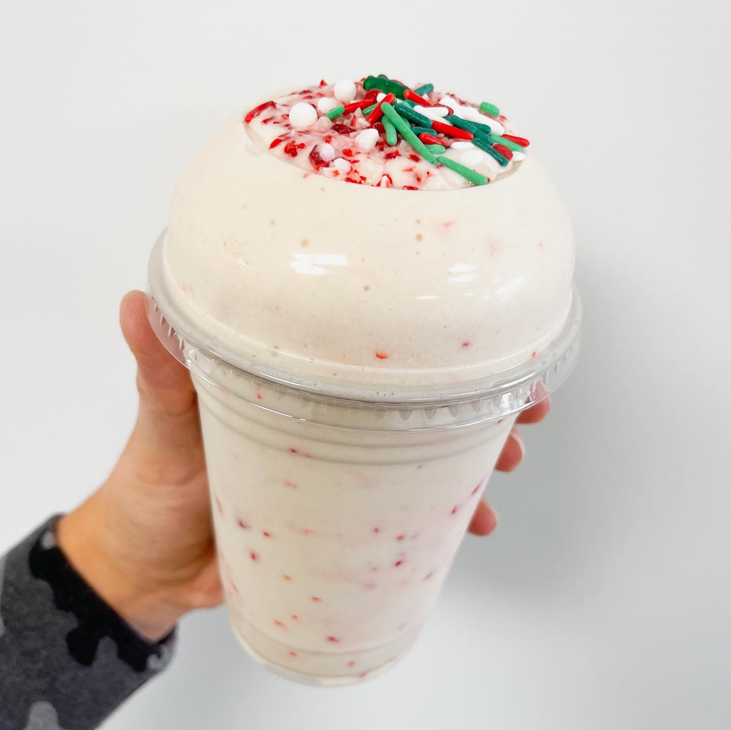 a smoothie with green and red sprinkles on top