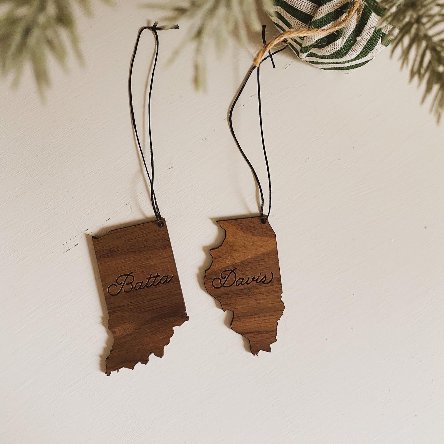 two ornaments made of wood shaped like the outline of indiana and illinois