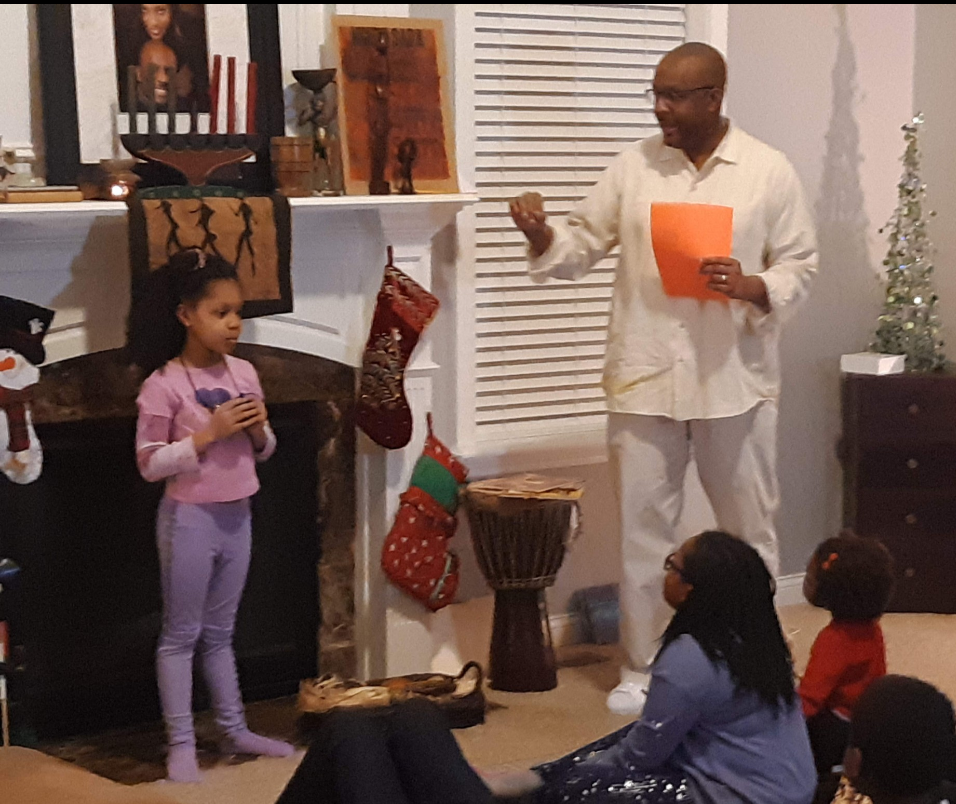 a dad teaching his family about kwanzaa