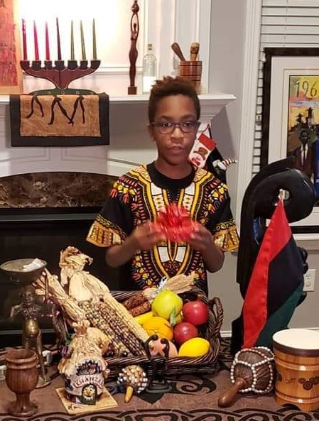 a boy celebrating Kwanzaa