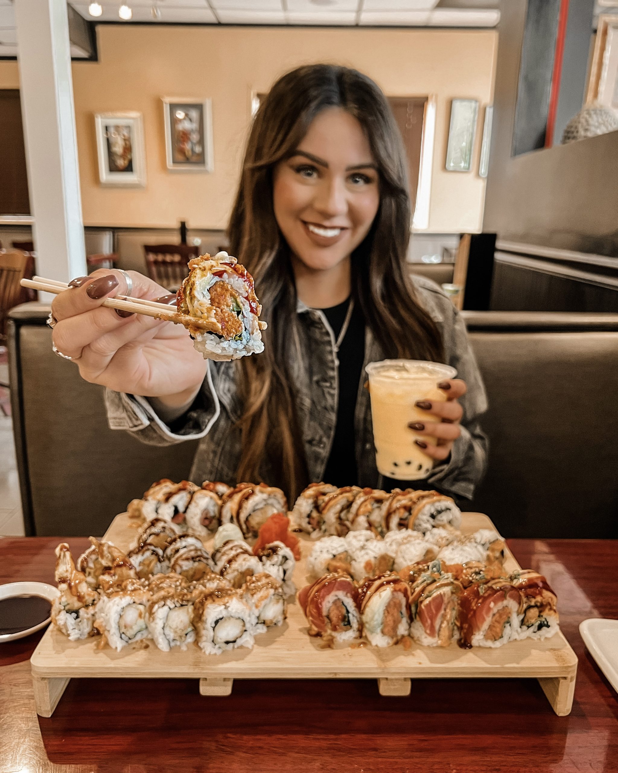 woman at table with sushi