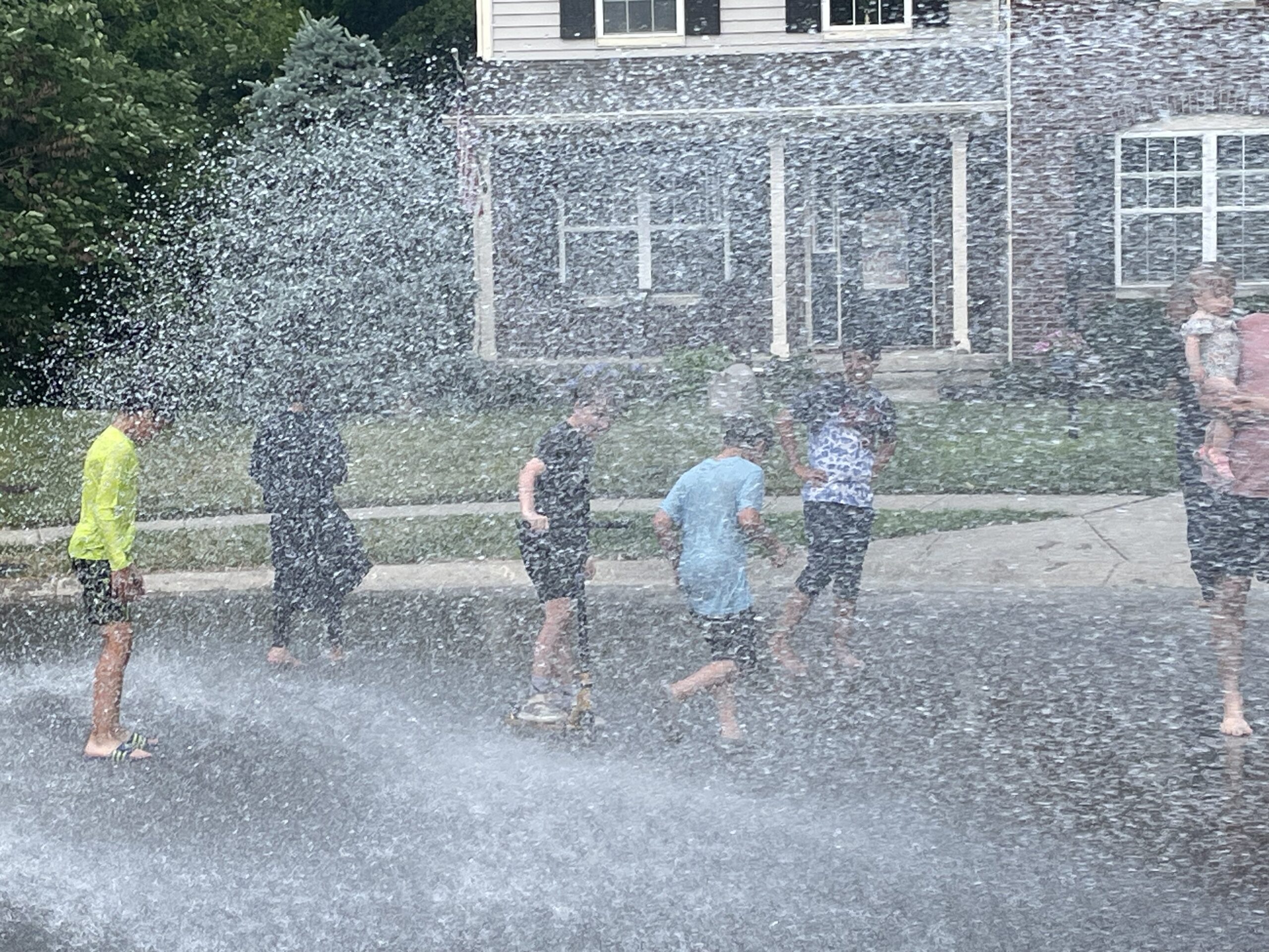 Kids playing in fire hose water