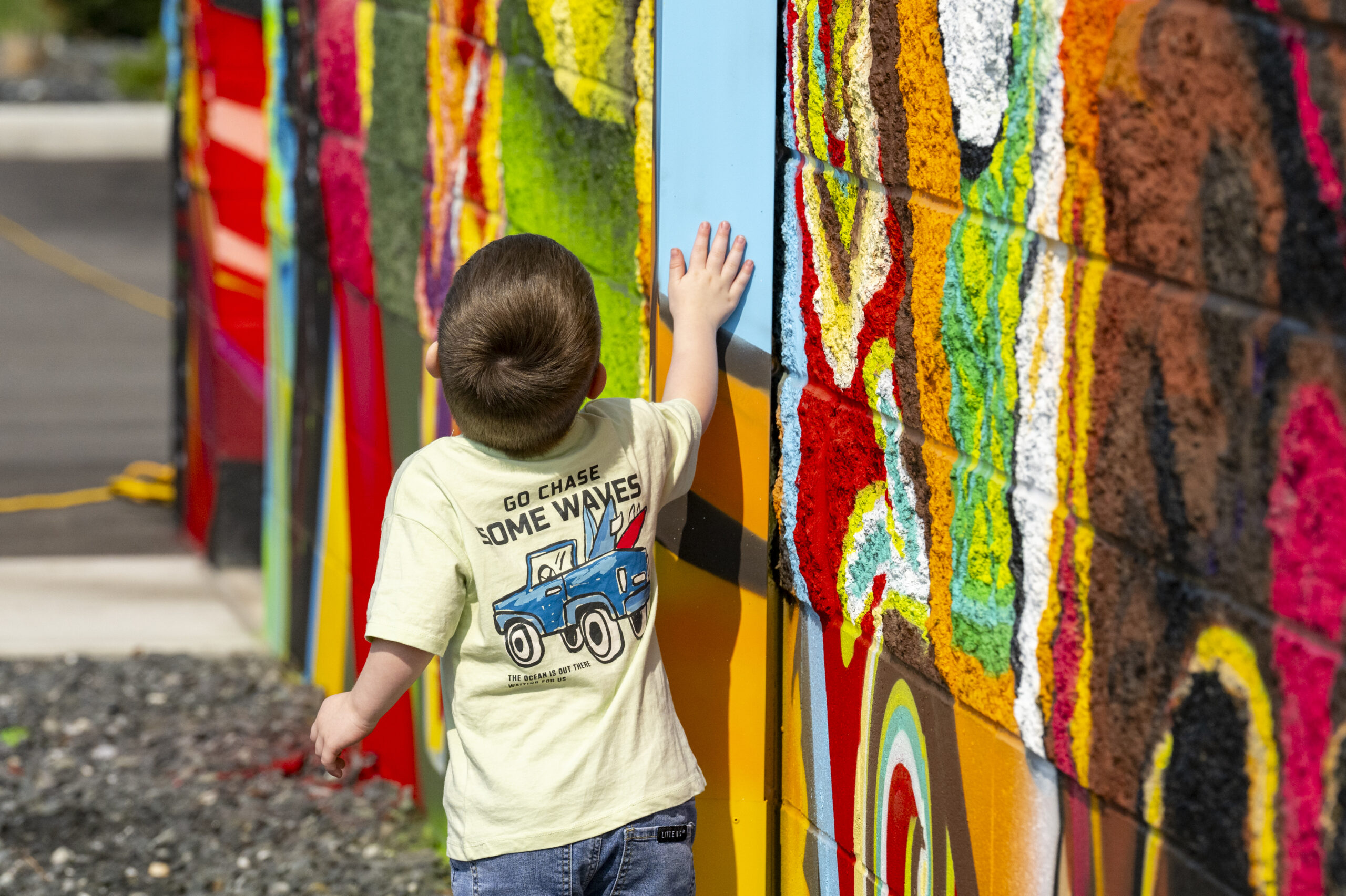 child looking up at mural